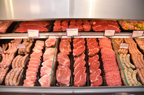 Meat service case with grass-fed beef, sausages, and more