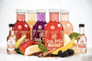 Bottles of Soul Brew Kombucha surrounded by fruit