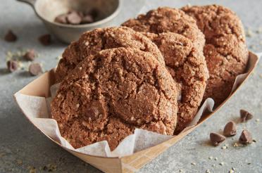 Double chocolate hemp heart cookies on a to go paper tray