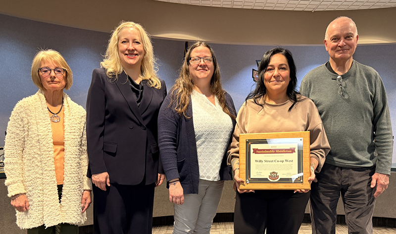 Five people, one of whom holds an award. From left to right: Deb Weitzel, Sustainability Committee Member; Kristie Pulvermacher, Sustainability Committee Member; Cari Johnson, Willy West Assistant Store Director; Frantseska Kois (holding the award), Willy West Store Director; Richard Lathrop, Sustainability Committee Member. The photo was taken in Middleton's City Hall in April.